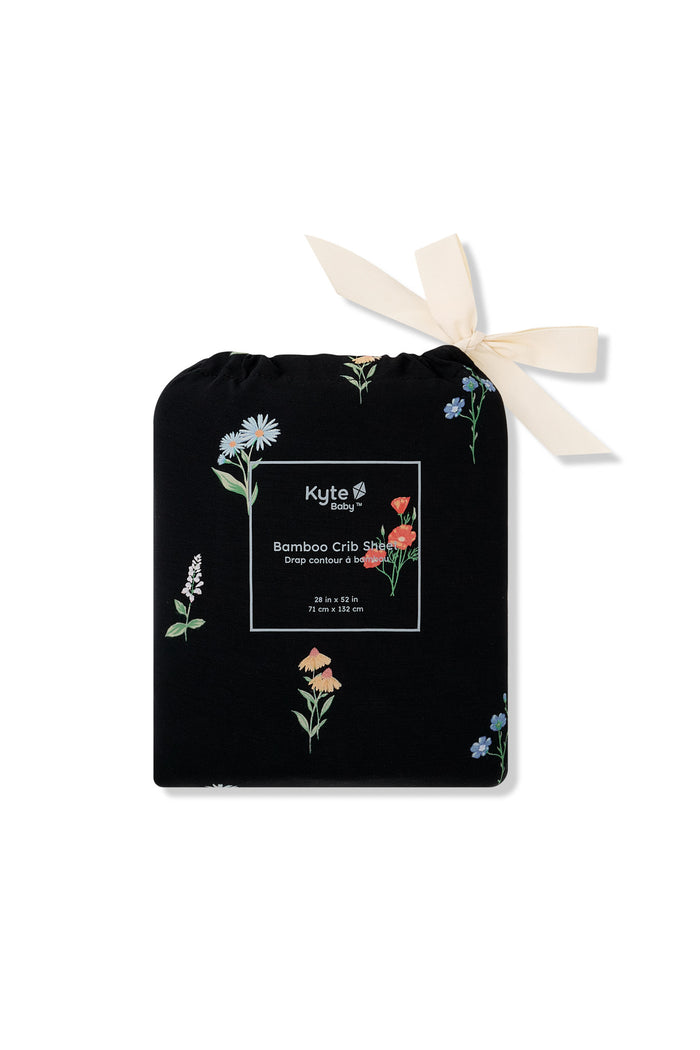 Black Crib Sheet in wildflower print packed in a black bag with Wildflower print on a white background