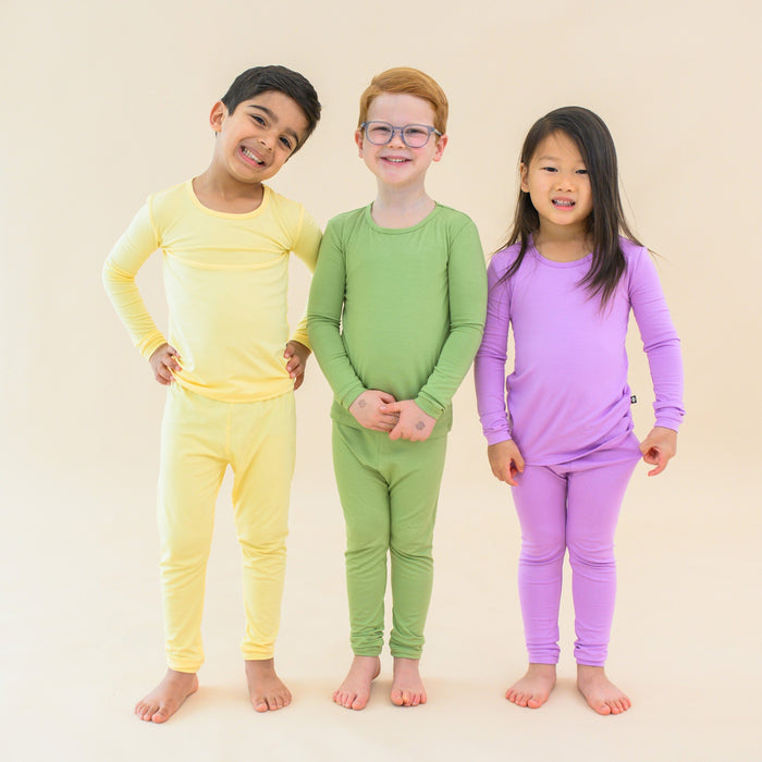 Toddlers in long sleeve pajamas in lilikoi, honu and poi