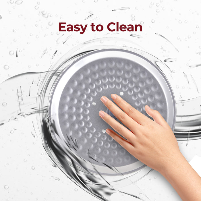 Easy to Clean: A hand washing the detachable inner lid of a Cuckoo rice cooker under running water. (CR-1095)