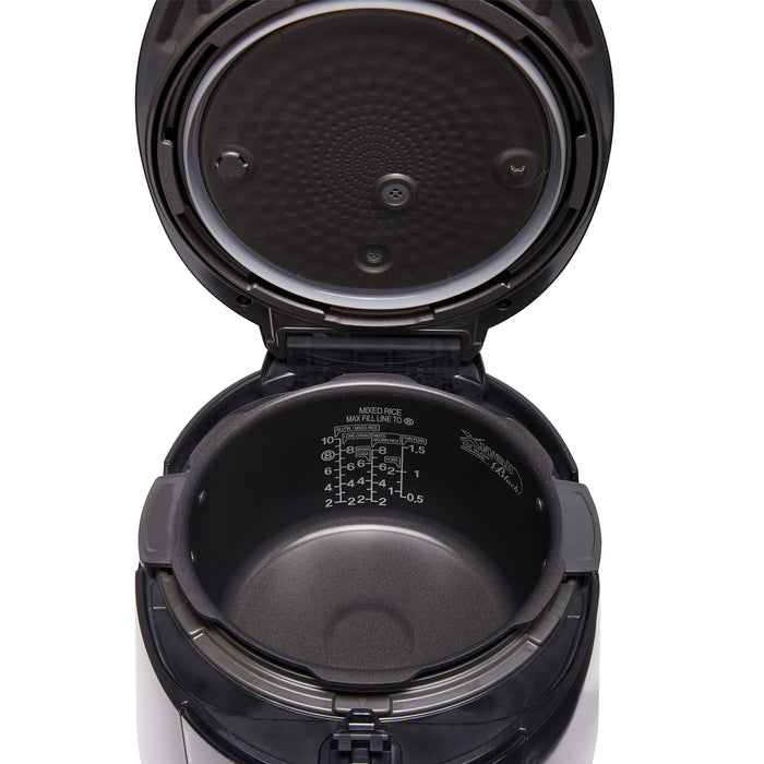 Close-up of an open CUCKOO rice cooker, showing the non-stick inner pot with water level markings and the inner lid cover. (CRP-PK1001S)