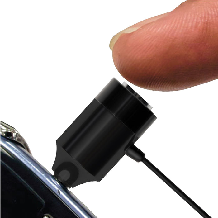 Finger pressing a small black magnetic charging adapter attached to a smartphone