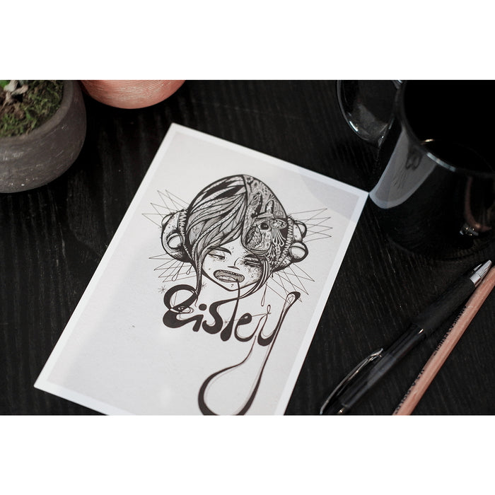 A photo of the "Eisley" Print on a table next to a coffee mug, next to the print are a pen and pencil.