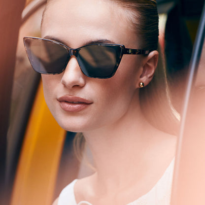 on model - female in a new york city cab wearing diff eyewear featuring the alina cat eye sunglasses with a espresso tortoise frame and grey lenses front view