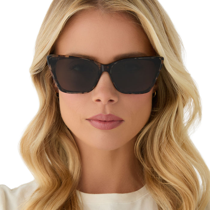 on model - female wearing diff eyewear featuring the alina cat eye sunglasses with a espresso tortoise frame and grey lenses front view