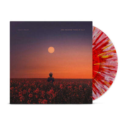 Brent Walsh’s limited pressing vinyl, “Are You Even There At All,” features a red and white splatter design and cover art of a person in a red flower field at sunset under a purple-orange sky.