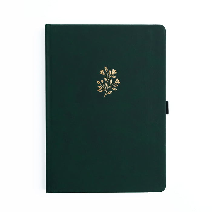 Dark green notebook with a gold floral design on a white background
