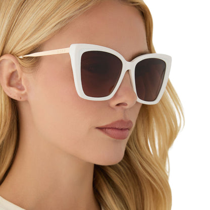 on model - blonde female wearing diff eyewear featuring the becky ii cat eye sunglasses with a snowbound white frame and brown gradient lenses angled view
