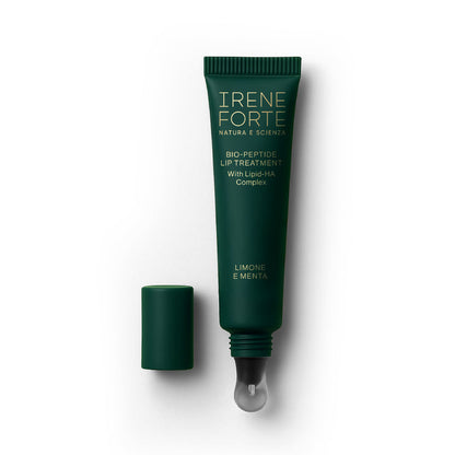 Green lip treatment tube with applicator on a white background