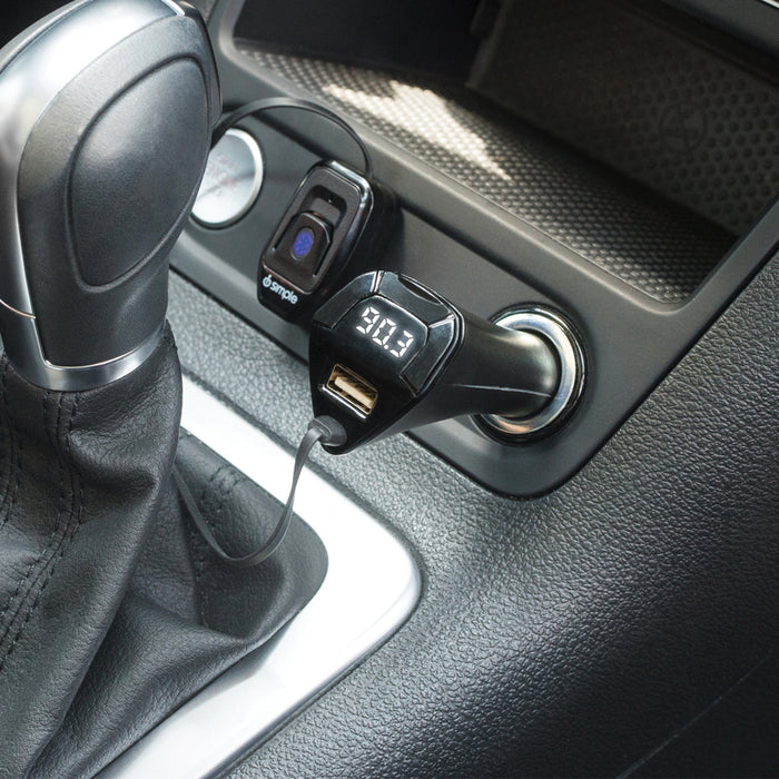 Bluetooth FM transmitter plugged into a car cigarette lighter port