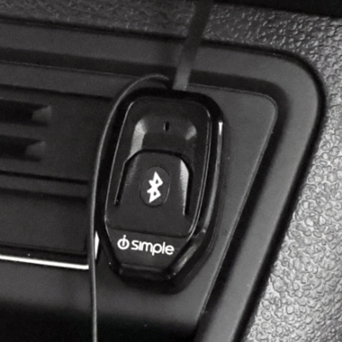 Black Bluetooth car adapter mounted on a vehicle dashboard