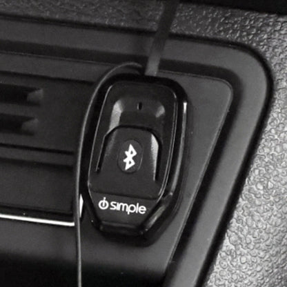 Black Bluetooth car adapter mounted on a vehicle dashboard