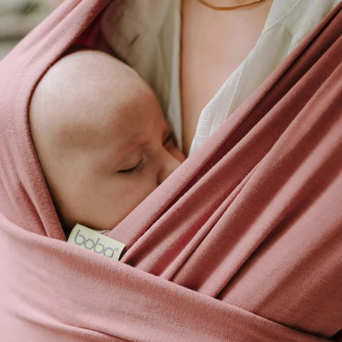 A Boba Classic Baby Wrap, made from a soft 95% French Terry cotton blend and 5% Spandex. Ergonomic, award-winning design fits babies from 7 Ibs to 35 Ibs, best up to 20 Ibs. Machine washable, dryer friendly, and certified hip-healthy. Dusty Pink