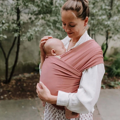 A Boba Classic Baby Wrap, made from a soft 95% French Terry cotton blend and 5% Spandex. Ergonomic, award-winning design fits babies from 7 Ibs to 35 Ibs, best up to 20 Ibs. Machine washable, dryer friendly, and certified hip-healthy. Dusty Pink