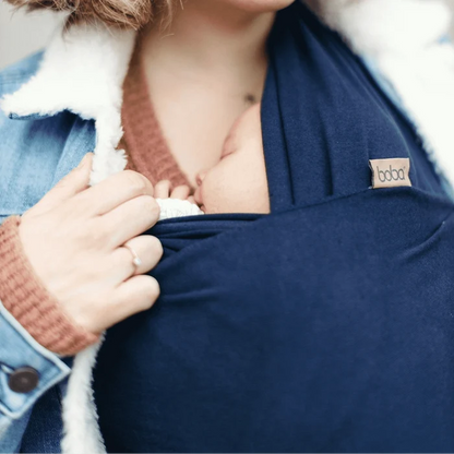 A Boba Classic Baby Wrap, made from a soft 95% French Terry cotton blend and 5% Spandex. Ergonomic, award-winning design fits babies from 7 Ibs to 35 Ibs, best up to 20 Ibs. Machine washable, dryer friendly, and certified hip-healthy. Navy Blue