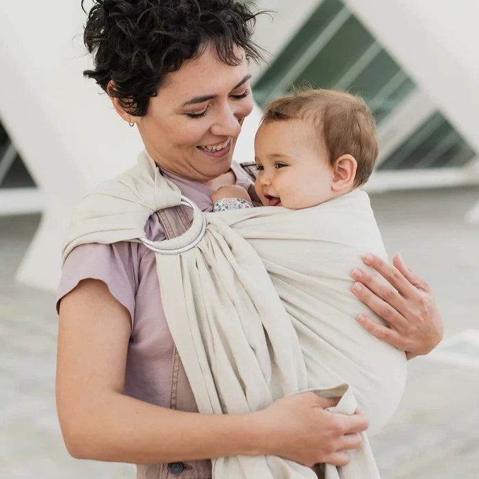A Boba Ring Sling Baby Carrier made from a unique linen bamboo viscose fabric blend, perfect for all seasons. Lightweight and breathable, it stores compactly, ideal for newborn snuggles to toddler ups and downs (8 - 35Ibs). Pampas Beige