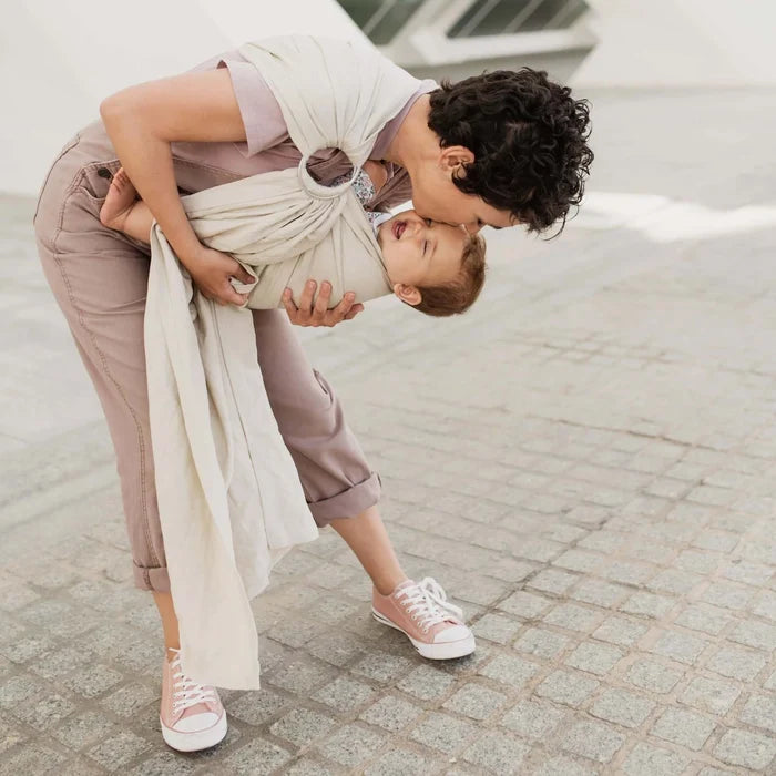 A Boba Ring Sling Baby Carrier made from a unique linen bamboo viscose fabric blend, perfect for all seasons. Lightweight and breathable, it stores compactly, ideal for newborn snuggles to toddler ups and downs (8 - 35Ibs). Pampas Beige