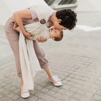A Boba Ring Sling Baby Carrier made from a unique linen bamboo viscose fabric blend, perfect for all seasons. Lightweight and breathable, it stores compactly, ideal for newborn snuggles to toddler ups and downs (8 - 35Ibs). Pampas Beige