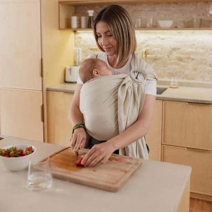 A Boba Ring Sling Baby Carrier made from a unique linen bamboo viscose fabric blend, perfect for all seasons. Lightweight and breathable, it stores compactly, ideal for newborn snuggles to toddler ups and downs (8 - 35Ibs). Pampas Beige