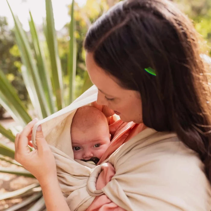 A Boba Ring Sling Baby Carrier made from a unique linen bamboo viscose fabric blend, perfect for all seasons. Lightweight and breathable, it stores compactly, ideal for newborn snuggles to toddler ups and downs (8 - 35Ibs). Pampas Beige