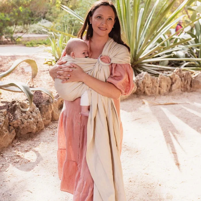 A Boba Ring Sling Baby Carrier made from a unique linen bamboo viscose fabric blend, perfect for all seasons. Lightweight and breathable, it stores compactly, ideal for newborn snuggles to toddler ups and downs (8 - 35Ibs). Pampas Beige