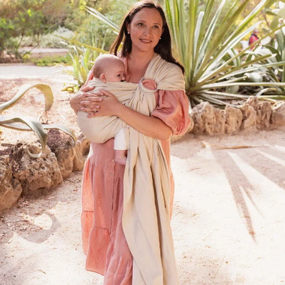 A Boba Ring Sling Baby Carrier made from a unique linen bamboo viscose fabric blend, perfect for all seasons. Lightweight and breathable, it stores compactly, ideal for newborn snuggles to toddler ups and downs (8 - 35Ibs). Pampas Beige