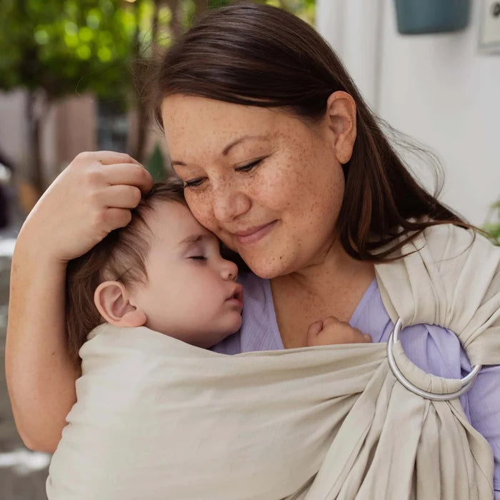 A Boba Ring Sling Baby Carrier made from a unique linen bamboo viscose fabric blend, perfect for all seasons. Lightweight and breathable, it stores compactly, ideal for newborn snuggles to toddler ups and downs (8 - 35Ibs). Pampas Beige