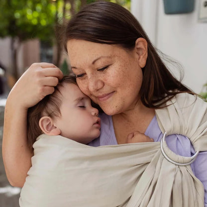 A Boba Ring Sling Baby Carrier made from a unique linen bamboo viscose fabric blend, perfect for all seasons. Lightweight and breathable, it stores compactly, ideal for newborn snuggles to toddler ups and downs (8 - 35Ibs). Pampas Beige
