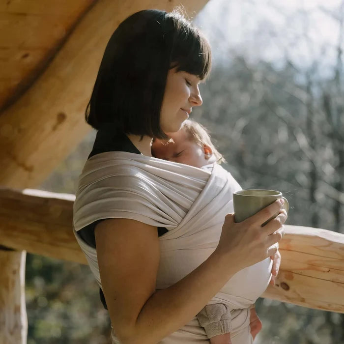 A Boba Serenity Baby Wrap, made from a buttery soft, extra breathable bamboo blend fabric (68% Viscose from Bamboo, 25% Cotton, 7% Spandex). Ergonomic, award-winning design fits babies from 7 Ibs to 35 Ibs, best up to 20 Ibs. Machine washable, dryer friendly, and certified hip-healthy. Organic Stone