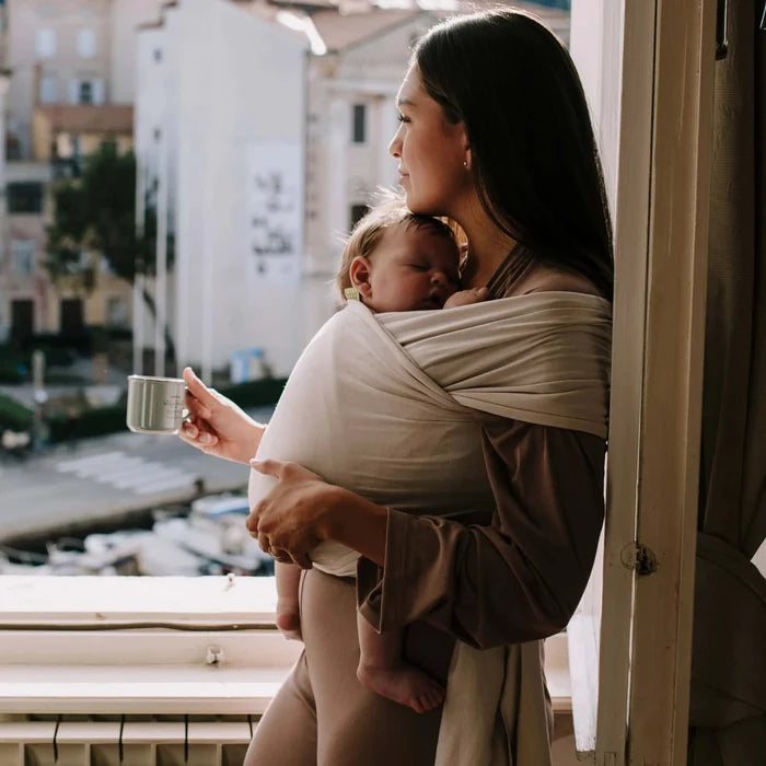 A Boba Serenity Baby Wrap, made from a buttery soft, extra breathable bamboo blend fabric (68% Viscose from Bamboo, 25% Cotton, 7% Spandex). Ergonomic, award-winning design fits babies from 7 Ibs to 35 Ibs, best up to 20 Ibs. Machine washable, dryer friendly, and certified hip-healthy. Organic Stone