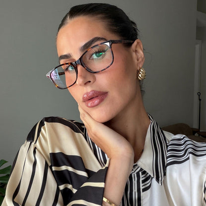 lifestyle - rachel boniske wearing brown tortoise eyeglasses wearing stripe blouse