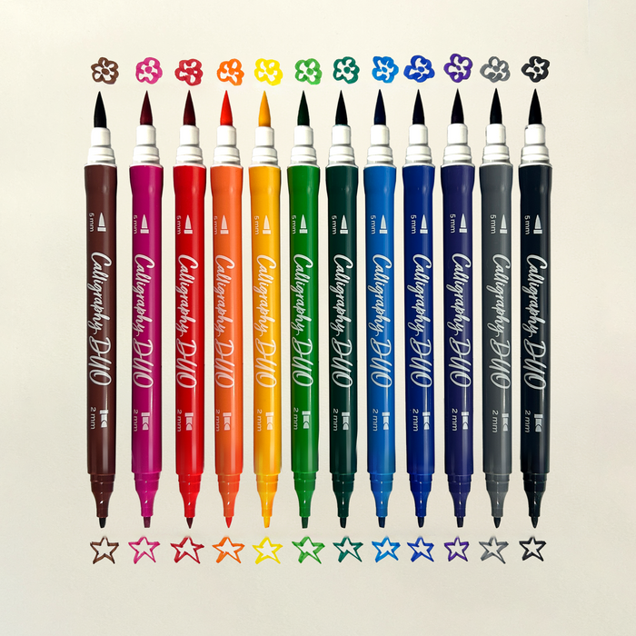 Row of OOLY Calligraphy Duo Double-Ended Markers with chisel and brush tip swatches