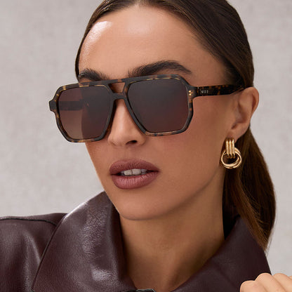 on model - female wearing diff eyewear featuring the cameron navigator sunglasses with a espresso tortoise frame and brown gradient polarized lenses angled view