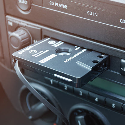 Cassette tape adapter inserted into a car stereo