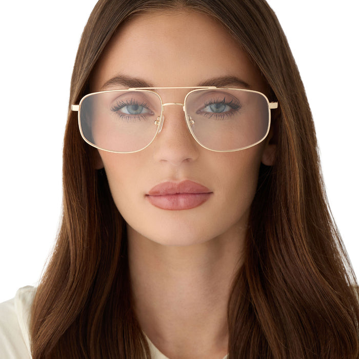 on model - female wearing diff eyewear featuring the charley navigator glasses with a gold metal frame front view