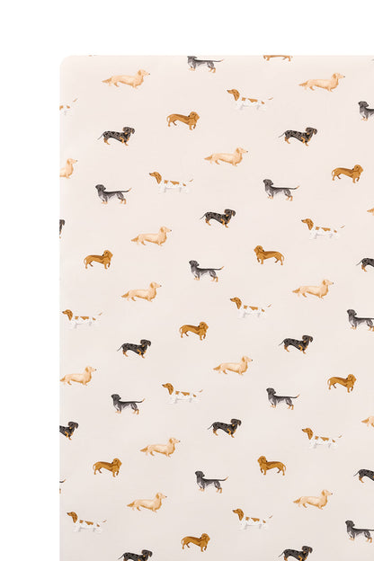 Beige Crib sheet with Dachshund print on a white background