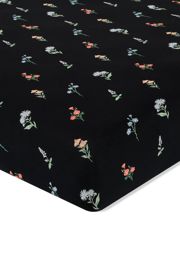 Black Crib Sheet in Wildflower print on a white background