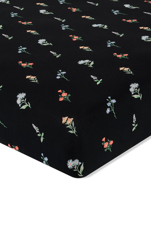 Black Crib Sheet in Wildflower print on a white background