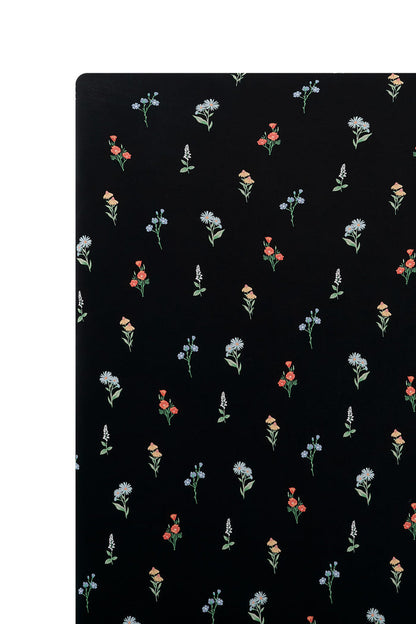 Black Crib Sheet in Wildflower print on a white background