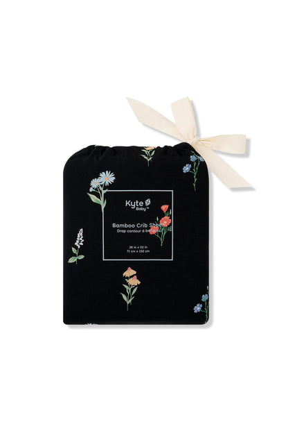 Black Crib Sheet in wildflower print packed in a black bag with Wildflower print on a white background