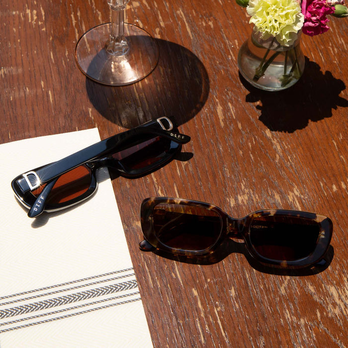 group shot of daphne sunglasses laying on a table outside