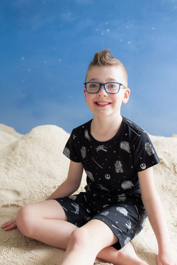 Young boy sitting in the sand wearing the Drawstring Short in STAR WARS™