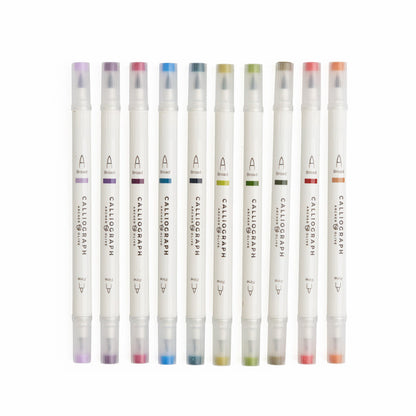 Set of Calligraphic markers with colored caps on a white background