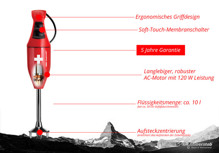 Der ESGE Zauberstab E 120 Design Rot 915101, ein roter Stabmixer von ESGE Zauberstab, verfügt über einen ergonomischen Griff, einen Soft-Touch-Schalter, 5 Jahre Garantie, einen langlebigen 120-W-Motor, 1 Liter Fassungsvermögen und eine einfache Aufsatzausrichtung; Matterhorn im Hintergrund.