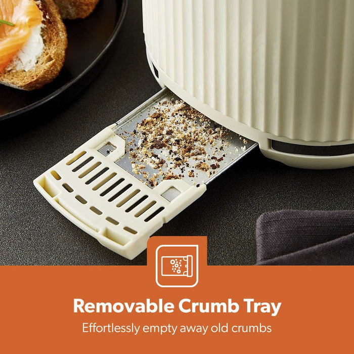 Removable crumb tray attached to a bread toaster with food on a counter.