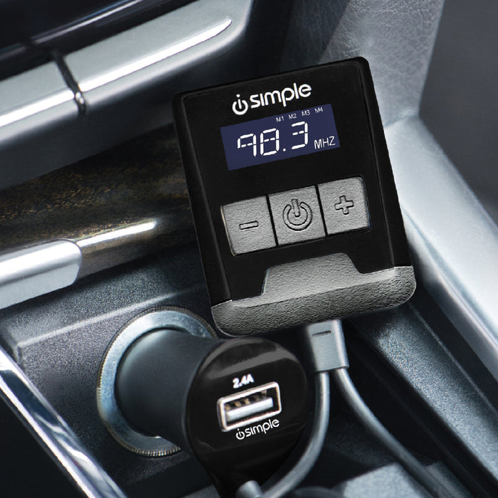 Simple FM transmitter with digital display and USB car charger plugged into a vehicle console