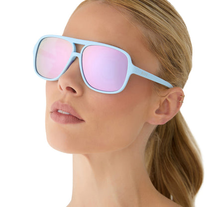 on model - female wearing diff sport featuring the hangtime aviator sunglasses with a matte baby blue frame and lavender mirror polarized lenses side view