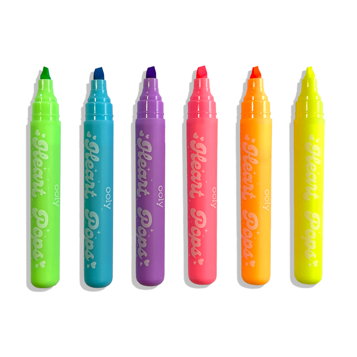 Row of uncapped OOLY Heart Pops Neon Highlighters on a white background