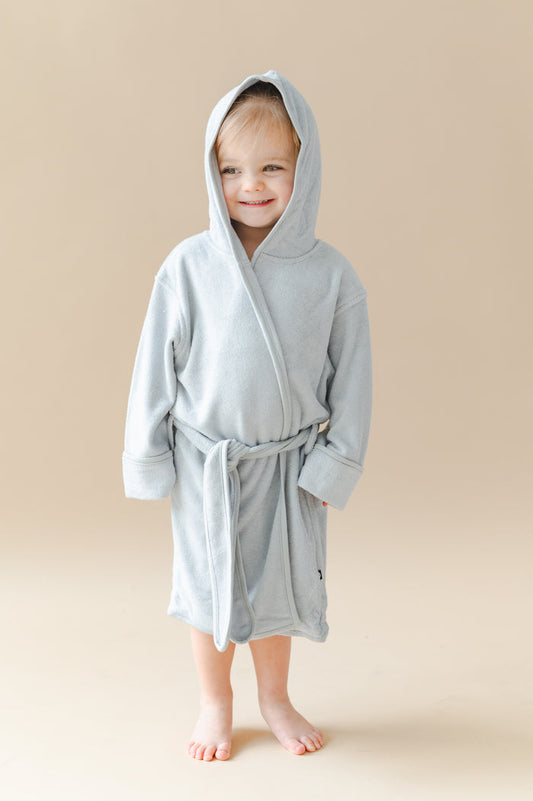 Young girl wearing the Hooded Bath Robe in Storm with the hood up