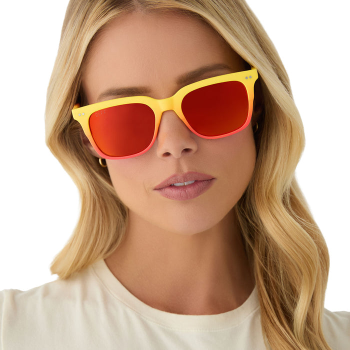 on model - female wearing diff eyewear x fantastic four featuring the human torch square sunglasses with a radiant yellow to orange frame fade and blazing red orange mirror polarized lenses front view