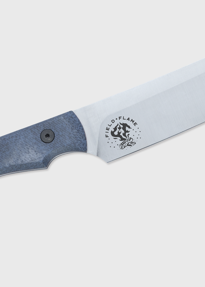 Close-up of a knife with a blue handle and "Field + Flame" logo on the blade, set against a plain background.